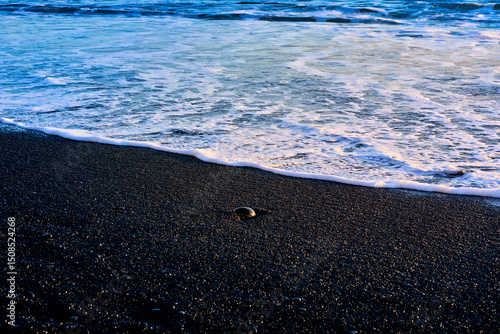 White poem black sand beach and ocean blue water on evening time in vik , Island , for travel destionation.