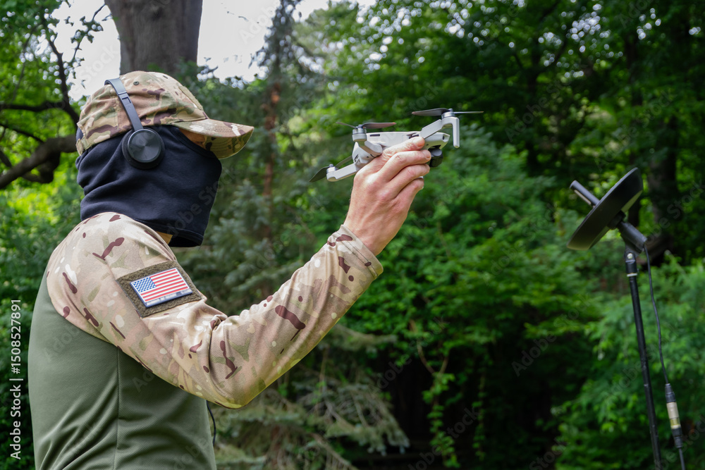 Fototapeta premium A military operator uses a drone and satellite communications for a tactical mission.