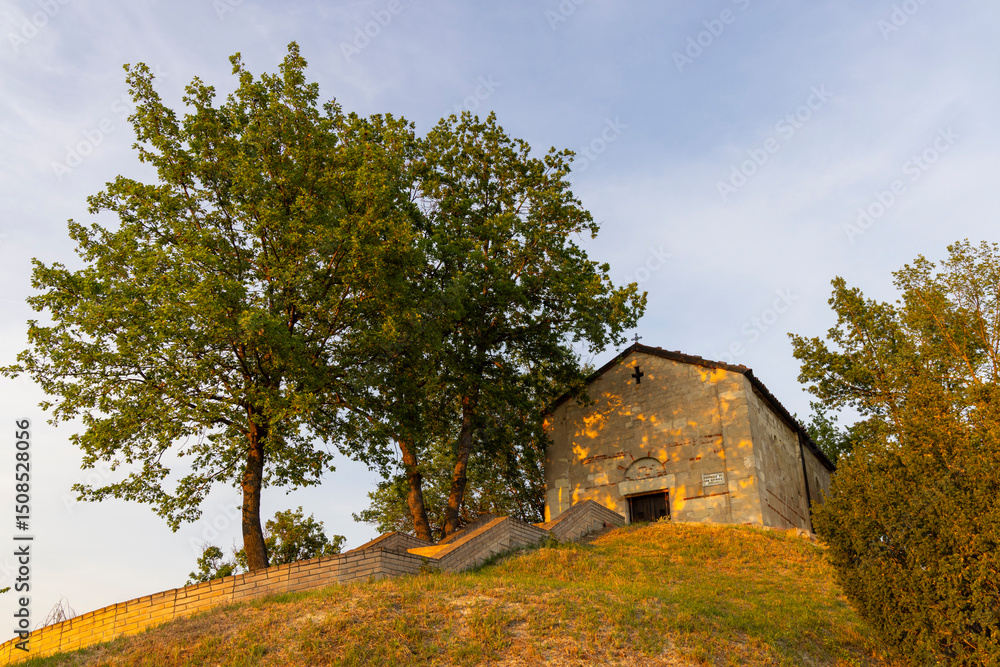 Obraz premium Small Rural Church on Hilltop at Golden Hour in Treville, Piedmont, Italy