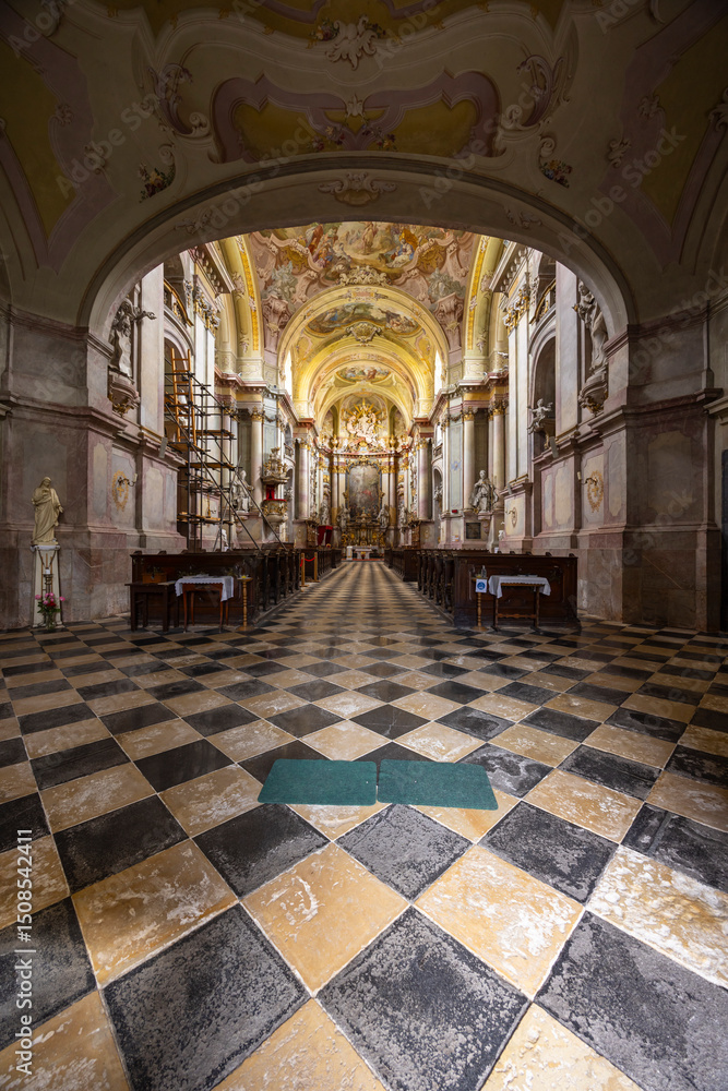 Obraz premium Interior of Jasov Monastery Church showcasing checkered floor and baroque architecture