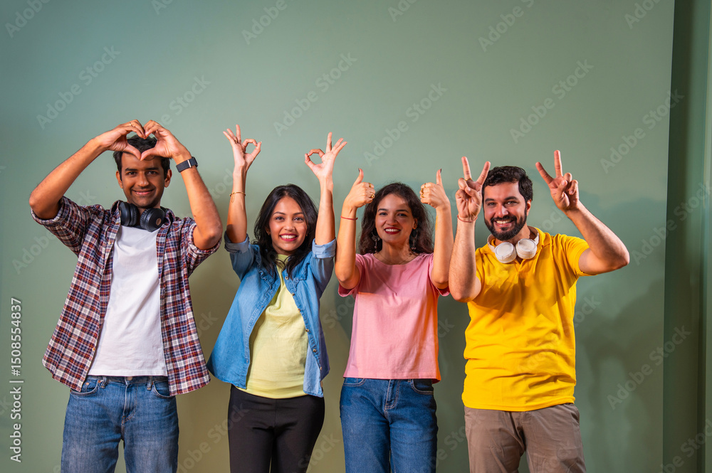 © StockImageFactory - Indian university group shows thumbs up and heart gesture while cheering and celebrating indoors © StockImageFactory - Indian university group shows thumbs up and heart gesture while cheering and celebrating indoors