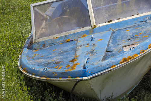 Photography Old abandoned boat resting on land covered in moss and rusting