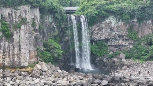 Aerial view of Jeongbang Waterfall in Jeju, South Korea - 4K Drone Video