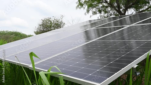 solar panels at a solar farm at bright sunset. Solar cell power plants. water system pumped with Solar panels. smart agriculture