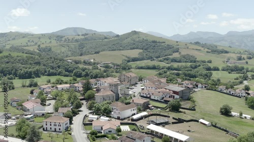 Wallpaper Mural Sweeping aerial view of Irissarry village surrounded by lush green hills and fields, Ospitalea, France Torontodigital.ca