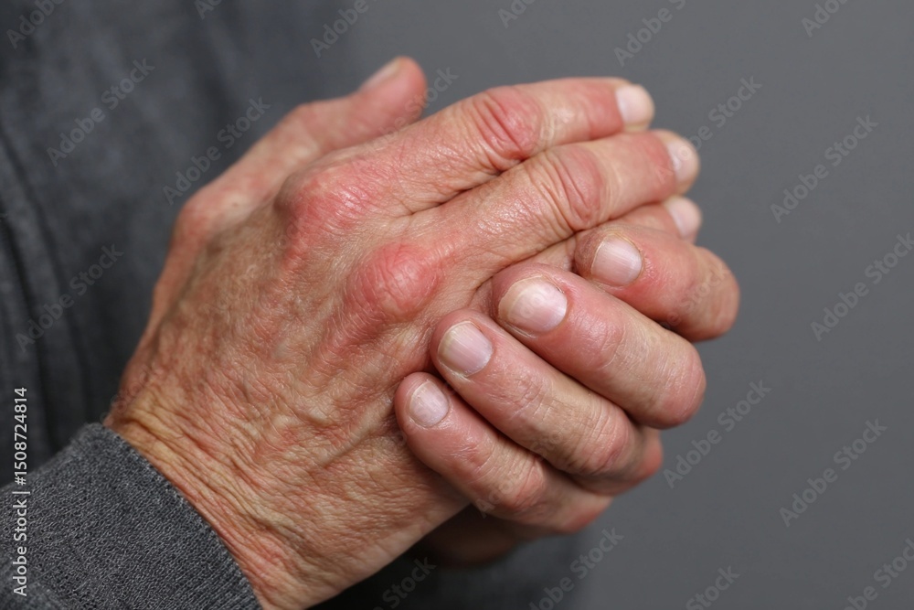 Fototapeta premium Elderly hands clasped together in contemplation, conveying wisdom and experience