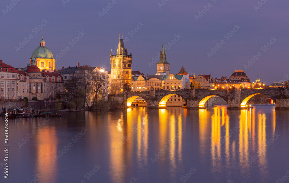 Fototapeta premium Illuminated Charles Bridge over the Vltava River at sunset in Prague Czech Republic