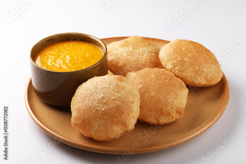 Photos Mango pulp or Aam Rus served in a ceramic bowl with puri or deep fried indian br