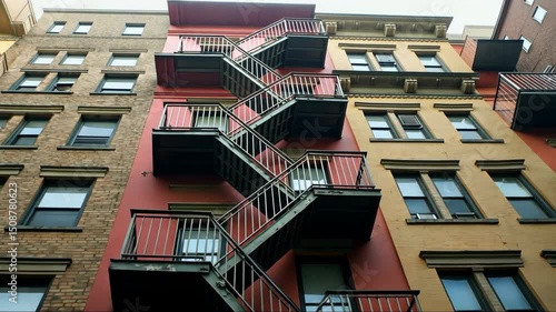 A multi-story building with a communal fire escape and a sense of community among residents,.