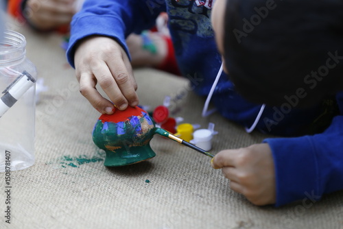 A little boy is painting