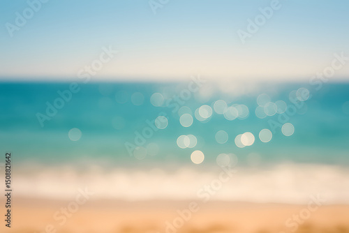 Soft-focus tropical seascape showing sandy beach and ocean with sunlit bokeh reflections, evoking vacation, calm, and summer..