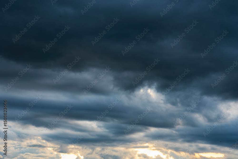 Obraz premium Dramatic dark storm thundercloud rain clouds on black sky background. Dark thunderstorm clouds rainny landscape. Meteorology danger windstorm disaster climate. Dark cloudscape storm disaster gray sky