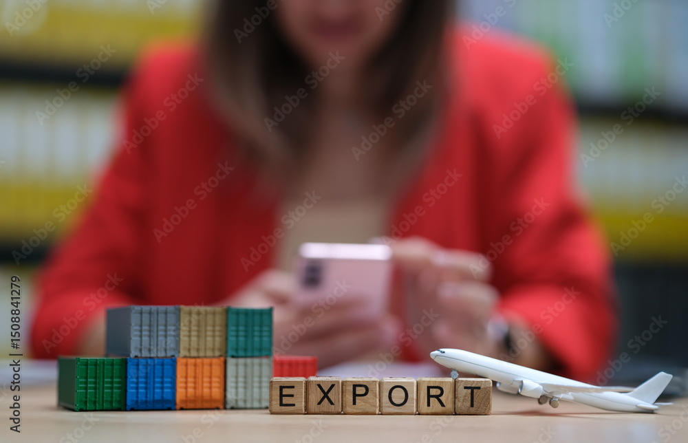 Fototapeta premium A visual representation of export with blocks, airplane, and mobile phone in a professional setting.