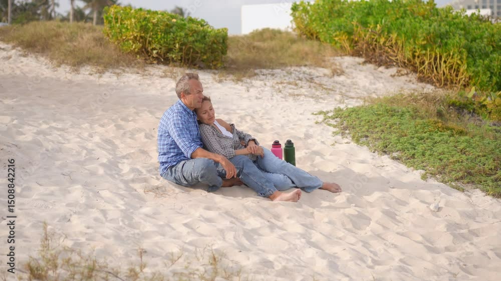 Romantic middle-aged couple enjoying a peaceful evening together on the beach. Love, connection, and togetherness concept for mature relationships and slow living lifestyle. Romantic middle-aged couple enjoying a peaceful evening together on the beach. Love, connection, and togetherness concept for mature relationships and slow living lifestyle.
