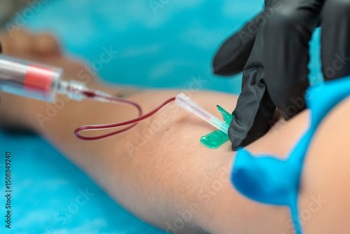 Nurse taking blood sample. Close-up view