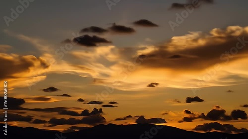 Wallpaper Mural Golden Sunset Sky With Dark Horizon Featuring Dynamic Cloud Formations in Shades of Orange Yellow and Dark Underlit Mountain Silhouette Torontodigital.ca
