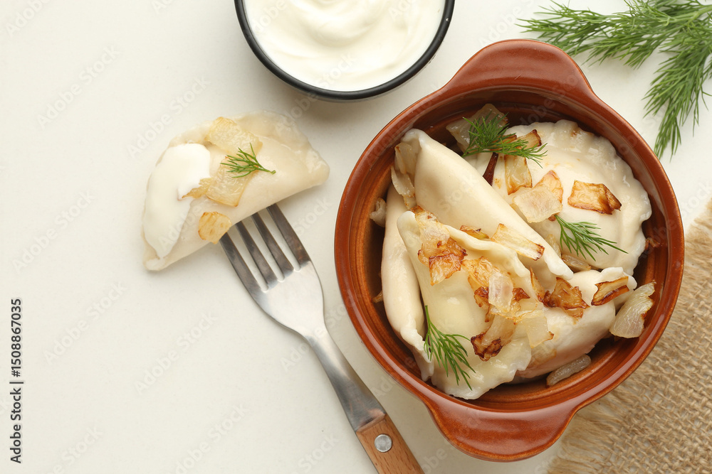 Traditional Ukrian food dumplings and sour cream Pierogi or pyrohy, varenyky, vareniki, dumplings served with caramelized salted onion in bowl Traditional Ukrian food dumplings and sour cream Pierogi or pyrohy, varenyky, vareniki, dumplings served with caramelized salted onion in bowl