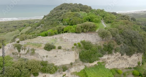 Aerial view of the archaeological excavations of Cuma, in the province of Naples, Campania, Italy. On the hill are the remains of the ancient city of Cumae, one of the oldest Greek colonies in Italy.