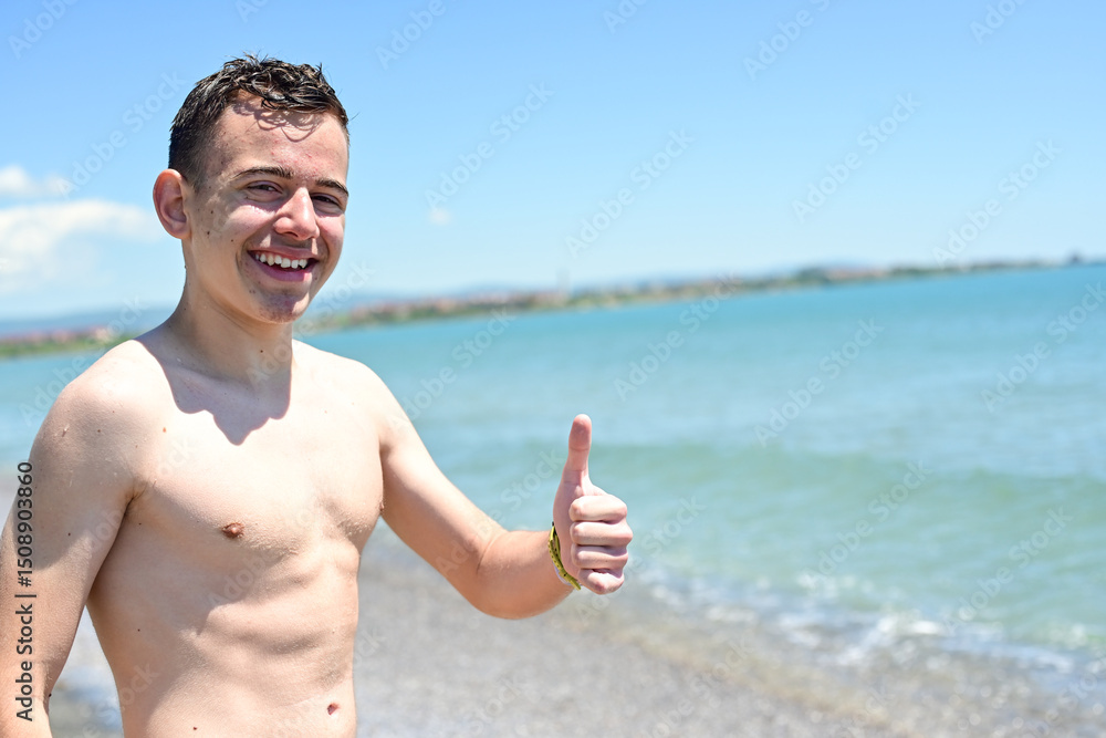 Smiling happy blond teenage boy enjoying the waterpark at vacation holidays at luxurious beachfront hotel Resort Smiling happy blond teenage boy enjoying the waterpark at vacation holidays at luxurious beachfront hotel Resort
