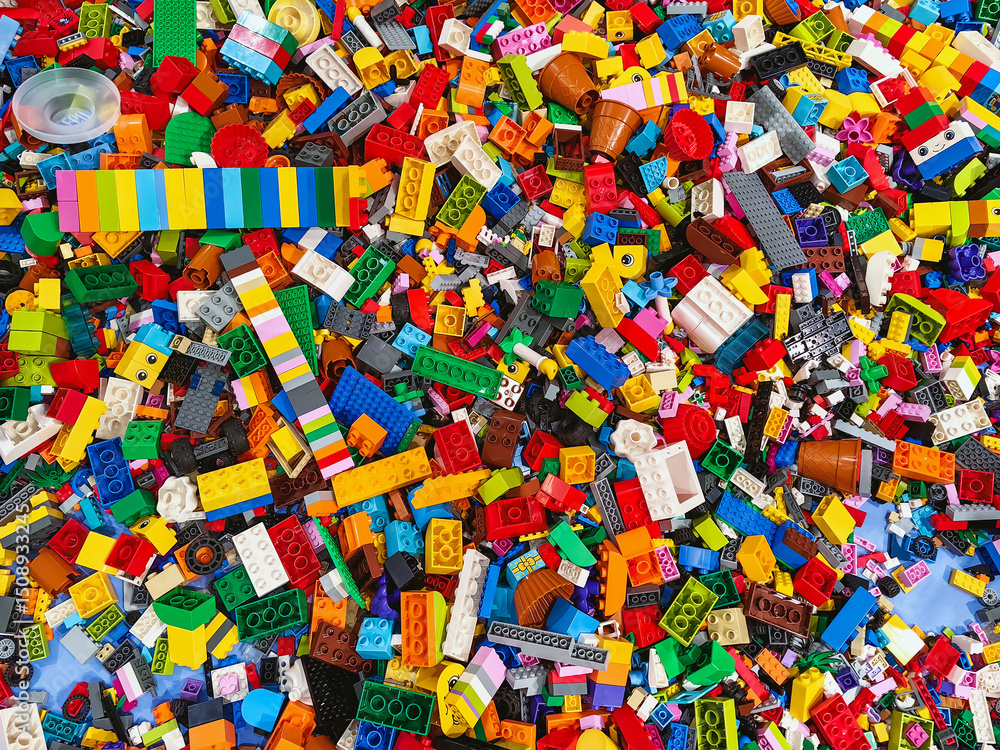 Naklejka premium NAKHON PATHOM,THAILAND - JANUARY 17 ,2025 : Top view A pile of multicolor of many Lego toy blocks in various shapes and different sizes at Central salaya. Toys and games. Leisure and recreation.