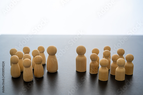 Conceptual representation, with wooden pawns, of gender differentiation and struggle. Males versus females, equality and gender parity.