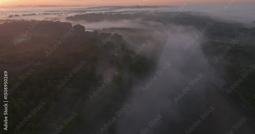 Aerial view of the morning mist and rising sun on the natural Drava River and forested floodplain Aerial view of the morning mist and rising sun on the natural Drava River and forested floodplain