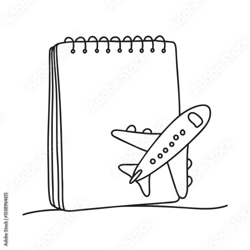 A toy airplane beside a sketchpad and marker