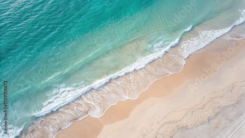 Serene aerial view of turquoise water meeting sandy beach.