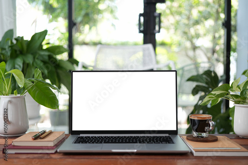 Laptop and glass cup of coffee during a coffee break