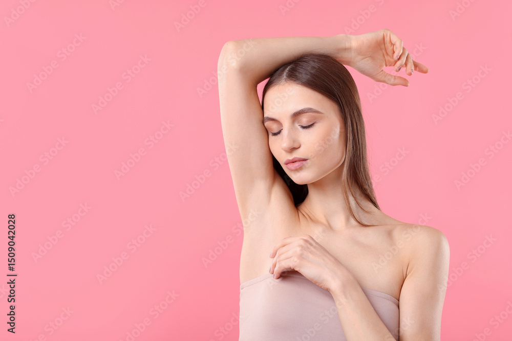 Obraz premium Young woman showing smooth skin after epilation on pink background, space for text