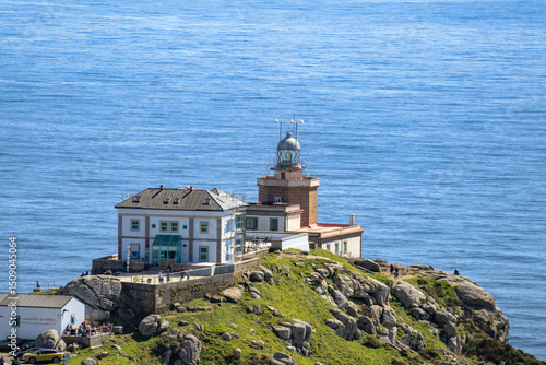 Finisterre, Galicia, Spain; April 6, 2025:  Panoramic shot from Mirador de Fisterra featuring the Atlantic horizon, steep cliffs, and the Finisterre lighthouse.  Atlantic coast. 
