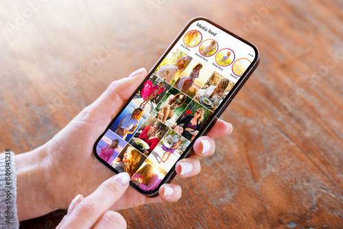 Woman viewing social media photo gallery on mobile phone