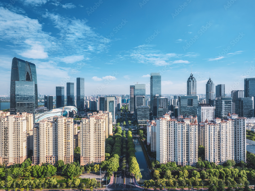 Fototapeta premium Panoramic of modern city skyline with a canal on a bright day in Suzhou, China. Urban background.
