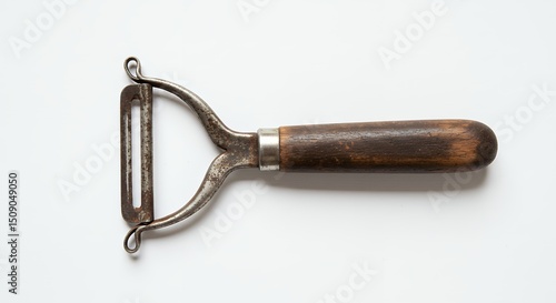 Vintage metal peeler with wooden handle
