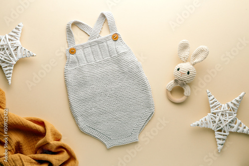 knitted baby romper and accessories on neutral fabric background flatlay newborn outfit