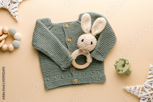 knitted baby romper and accessories on neutral fabric background flatlay newborn outfit
