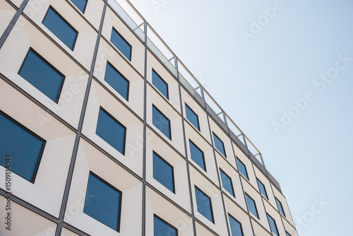 Wallpaper Mural Geometric facade with reflective windows in modern urban setting Torontodigital.ca