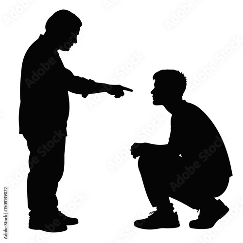Father scolding son during family conflict in silhouette  