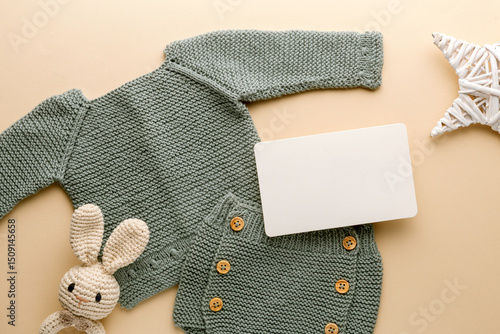 Newborn baby clothes mockup featuring hand-knitted, soft, and cozy babywear flatlay with a minimalist infant outfit