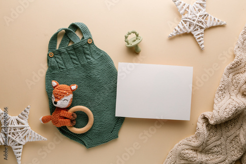 Newborn baby clothes mockup featuring hand-knitted, soft, and cozy babywear flatlay with a minimalist infant outfit