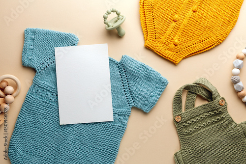 Newborn baby clothes mockup featuring hand-knitted, soft, and cozy babywear flatlay with a minimalist infant outfit
