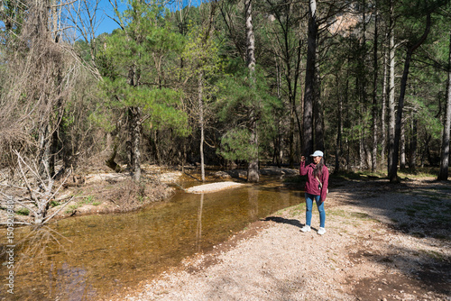 Wallpaper Mural Young Asian woman enjoying nature at Nacimiento Rio Mundo, Spain Torontodigital.ca
