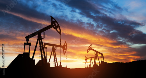 Oil drilling derricks at desert oilfield. The change in oil prices caused by the war. Oil price cap concept.