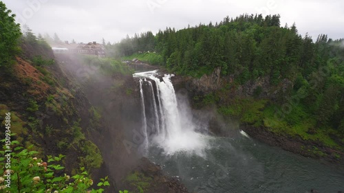 Snoqualmie Falls waterfall with lush greenery and mist in Washington State, USA. Snoqualmie Falls is a 268-foot waterfall on the Snoqualmie River between Snoqualmie and Fall City. 4K UHD video.