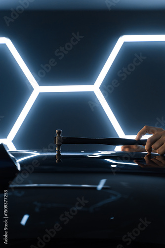 Wall Mural PDR hammer tool for paintless dent repair positioned above a car panel