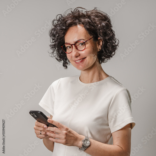 Wallpaper Mural studio shot of beautiful curly hair woman use mobile phone studio shot Torontodigital.ca