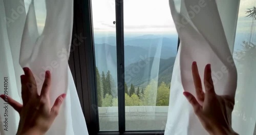 young woman looking through window