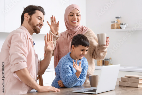 Happy Muslim family with la...