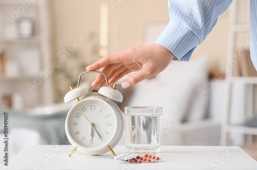 Woman turning off alarm clo...