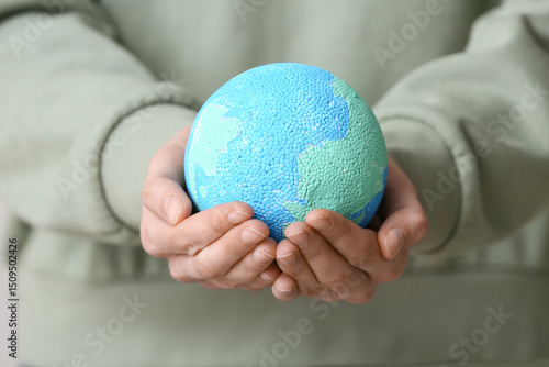 Woman with model of Earth o...